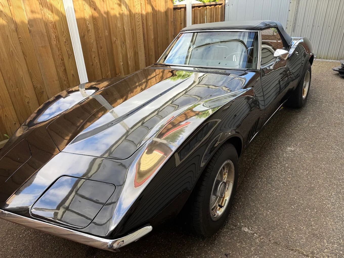 Classic black Corvette Stingray convertible, mirror-finish paint correction