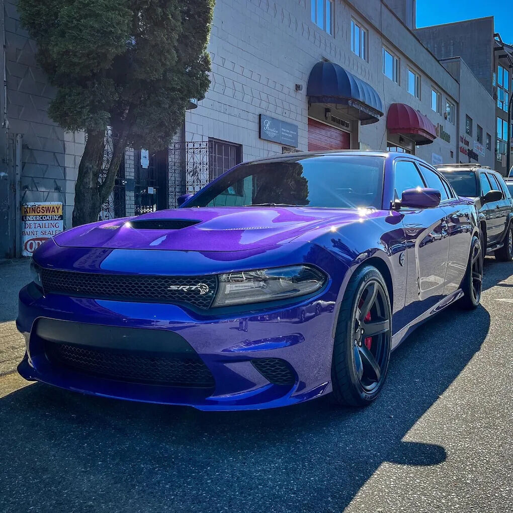Dodge Charger SRT Hellcat with a mirror-finish paint detail, reflecting the street around it